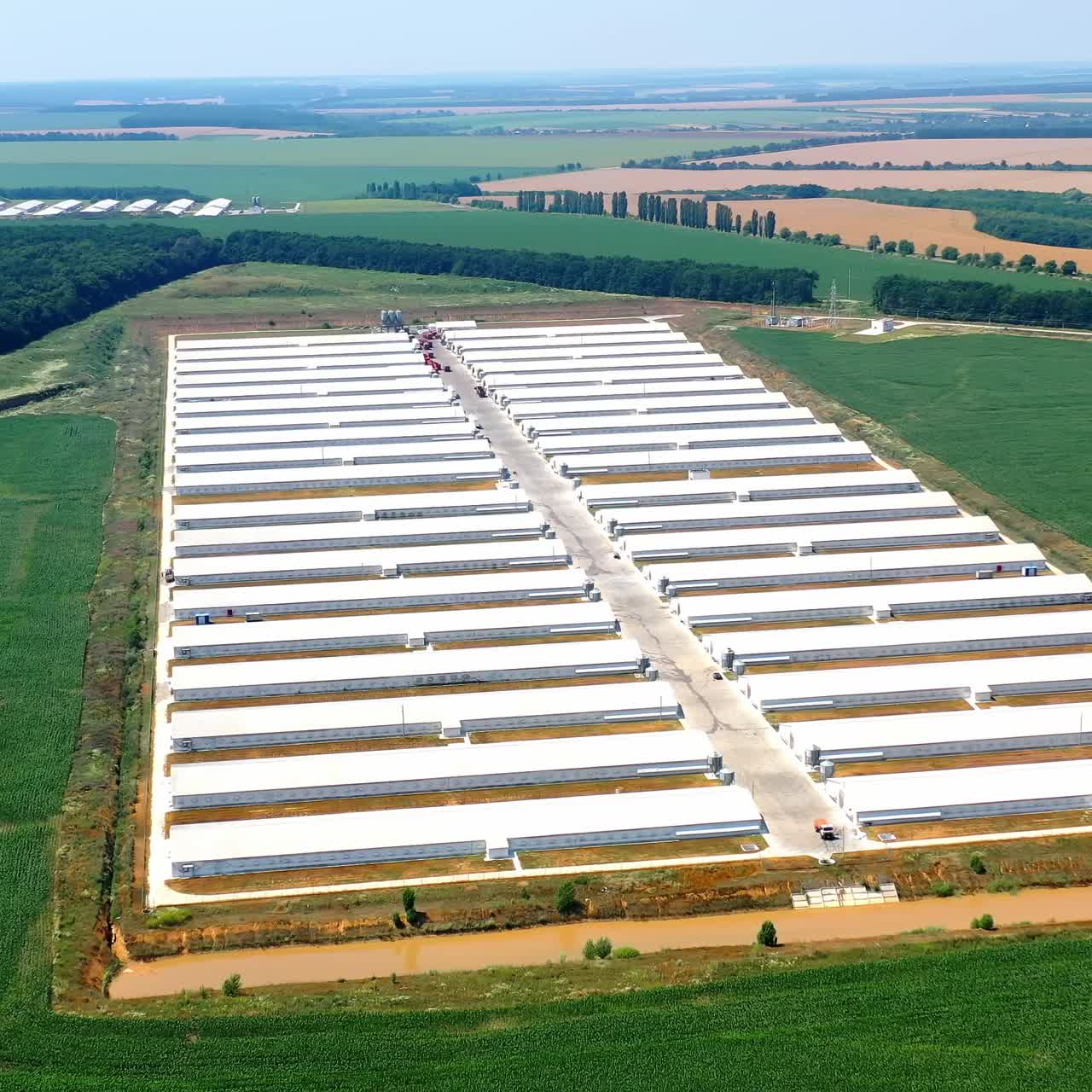 Flying drone of big farm. Aerial drone view of industrial poultry farm