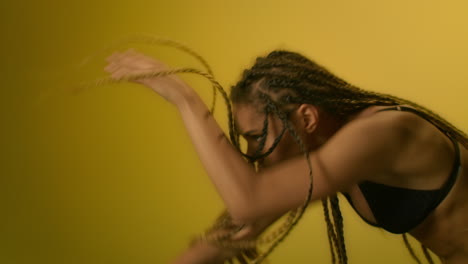 african woman dancing in black bikini