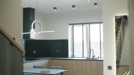 modern kitchen with wooden cabinets and black accents