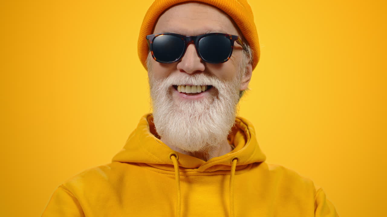Mature man posing to camera indoors. Cheerful guy enjoying lifestyle in studio.