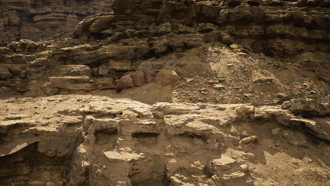 Desert rock formations display unique textures and colors by day