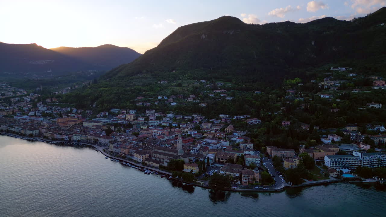 Europe, Italy, Brescia , Garda lake , Salo' drone aerial view of village with church and lake with blue water - Italian Republic from 1943 to 1945 during the reign of Benito Mussolini fascist