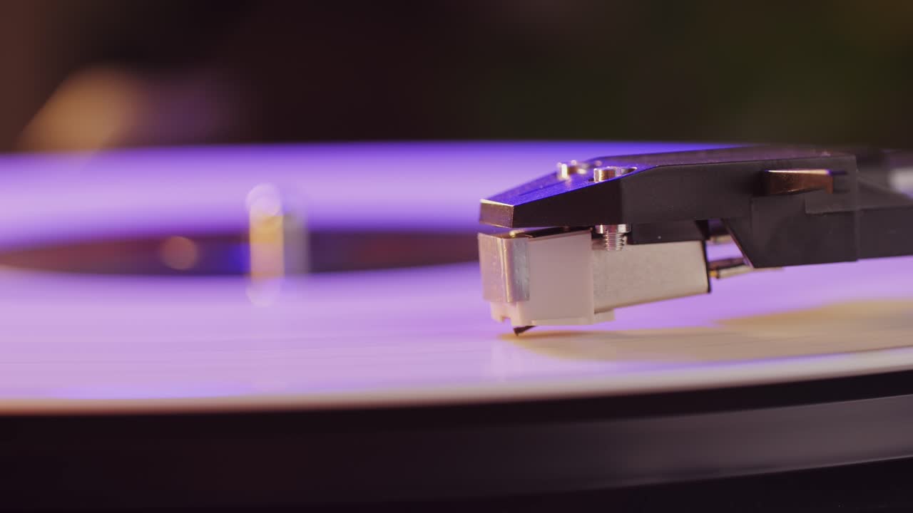 Retro Vinyl record player playing music, close-up macro shot of vintage LP disc old phonograph spinning. Retro music player.