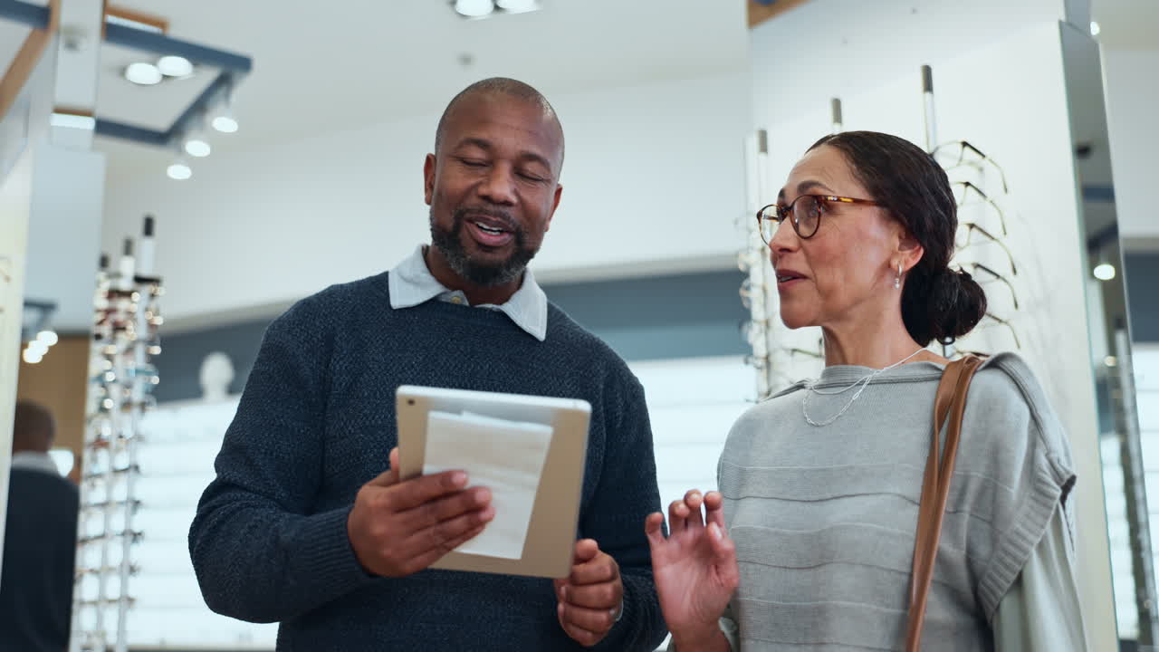 Optometrist helping a customer choose glasses
