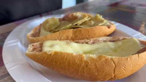 assembling fresh toast with melted cheese, close up