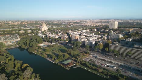 Ascending-Drone-Shot-Reveals-EUR-Lake-Park-on-Beautiful-Day-in-Rome,-Italy