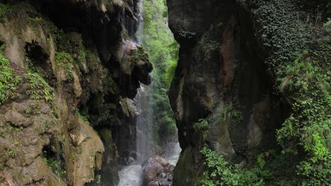 cinematic drone footage of umbrella waterfall in pakistan’s green hills