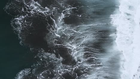 Aerial-view-of-some-powerful-ocean-waves-crashing-into-the-shore