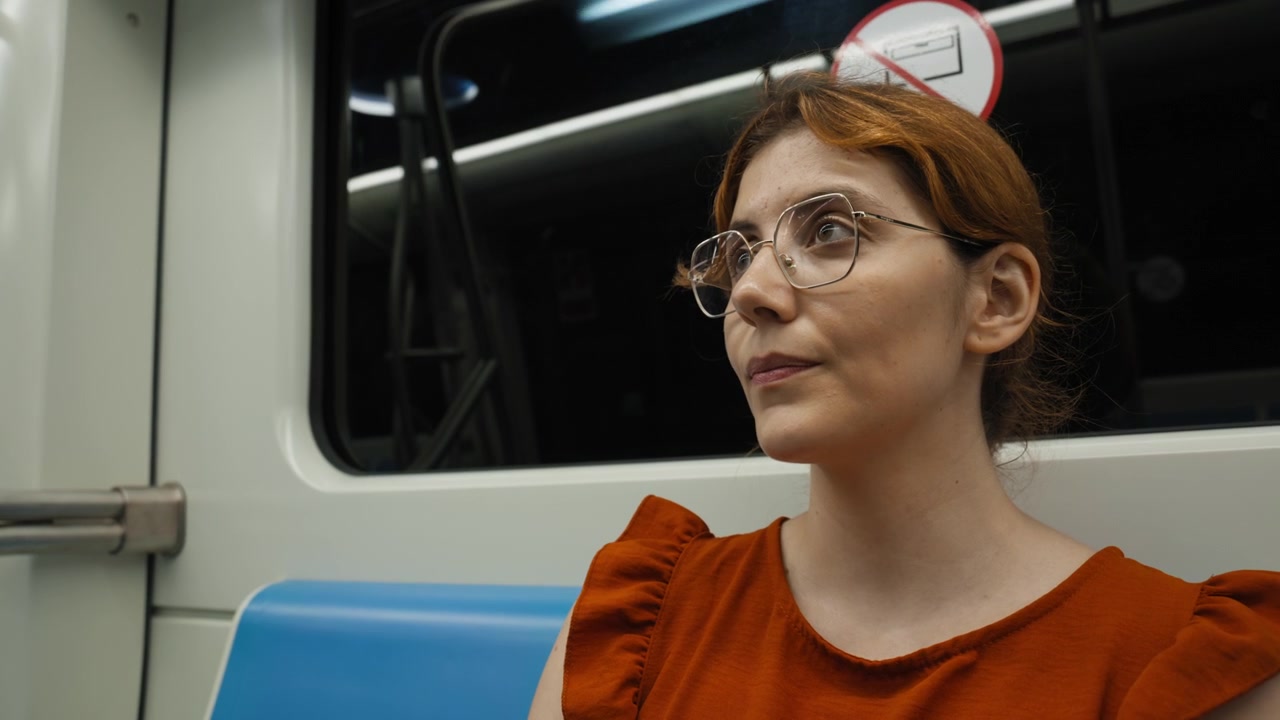 A female tourist travels while seated on the Naples subway metro train