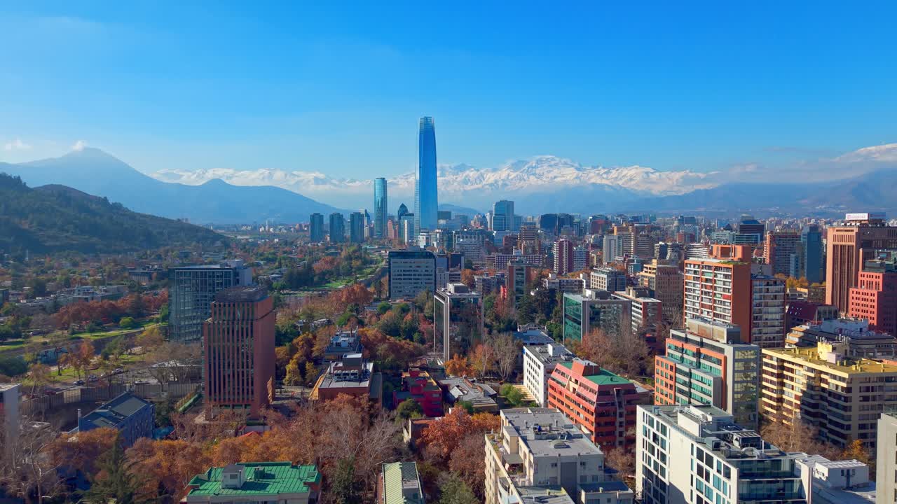 Rising shot of the Costanera Tower and Santiago skyline surrounded by the Andes