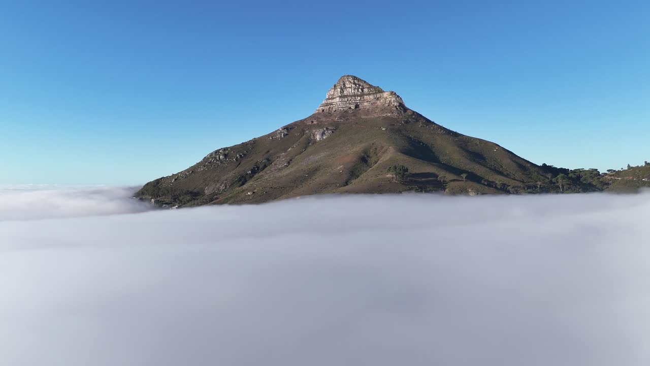 Aerial drone footage of Lion’s Head mountain in Cape Town, South Africa, surrounded by mist