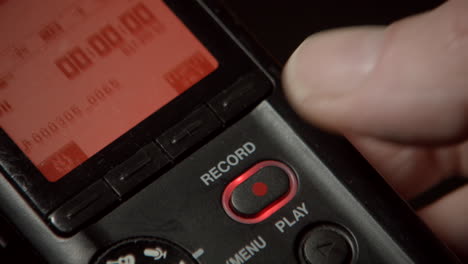 pushing record button on a handy digital recorder