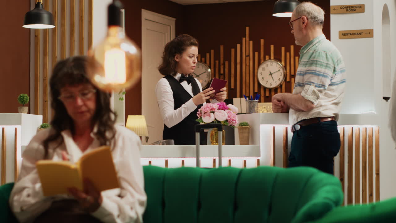 직원이 호텔에서 여권 정보를 확인합니다.