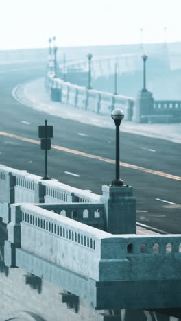 a wide shot of an empty bridge with fog in the distance.