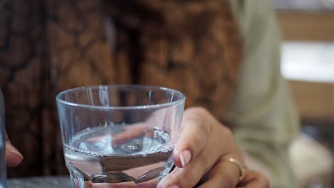 woman pouring water into a glass