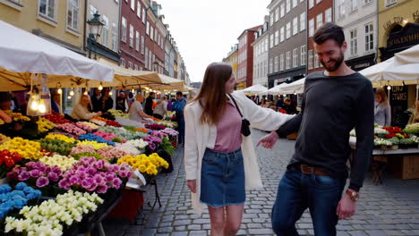 couple walking through a european street market