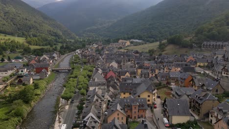 a captivating drone flight takes a leisurely journey over a picturesque spanish town nestled in the pyrenees mountains, gently tilting to unveil the vibrant life below