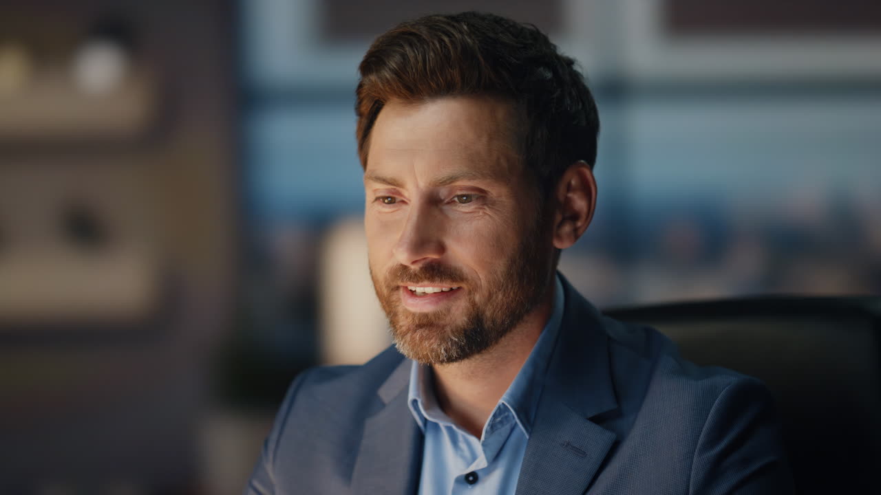 Smiling man working evening office closeup. Happy businessman reading good news