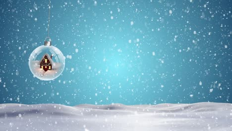 Animation-of-snow-falling-over-dangling-christmas-bauble-with-house-on-blue-background