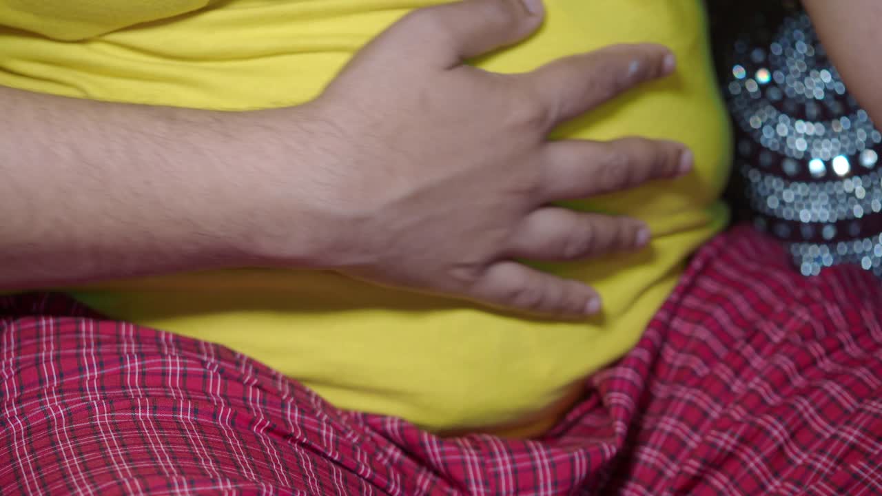 Man with hand on stomach