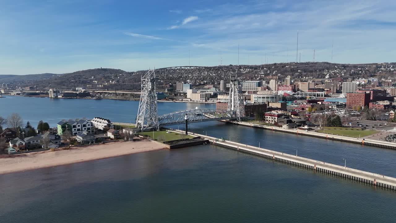 Aerial Lift Bridge in Duluth Minnesota. Drone Slowly Moving in. sunny day in early fall with party cloudy skies, Park Point.