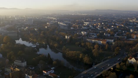 drone shot of the cityscape landscape of kassel in beautiuful soft sunlight and covered in fog