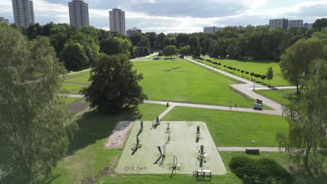 Parkside-during-a-beautiful-summer-day-surrounded-by-lush-greenery,-grass,-and-trees-under-a-blue-sky