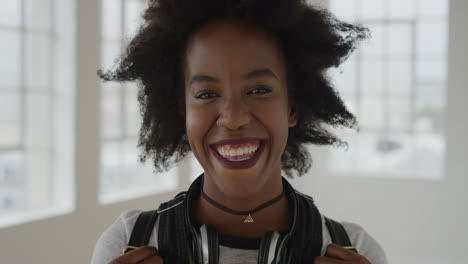 portrait of young african american woman smiling cheerful enjoying successful lifestyle positive independent black female with funky afro real people series