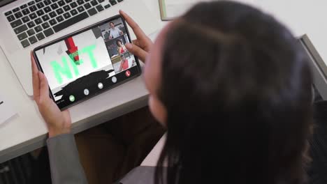 Biracial-businesswoman-using-tablet-for-video-call-with-diverse-business-colleagues