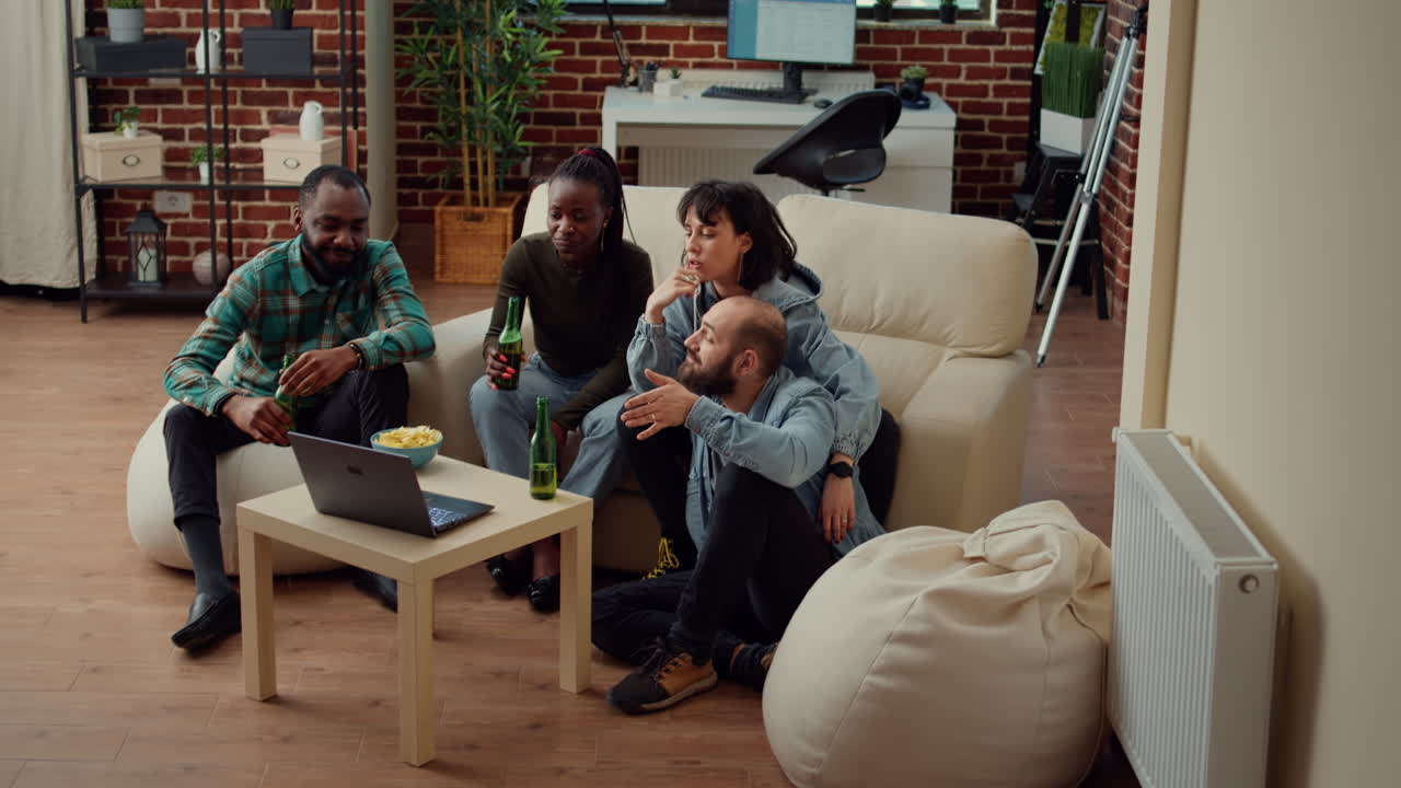 Diverse friends watching funny video on laptop