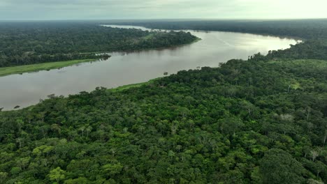 Aerial-drone-fly-view-of-scenic-sunrise-at-amazon-tropical-jungle-rainforest-with-vivid-fog-rays-in-the-morning-close-to-a-river-lake