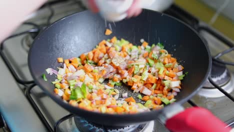 chopped mixed veggies in a pan sprinkled with iodized salt