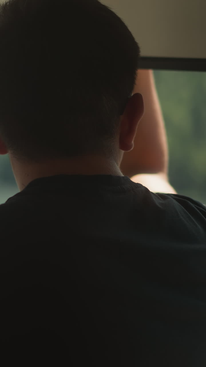 Young man drives fast yacht holding helm in cockpit. Rich tourist enjoys motor boat sailing at exotic cruise on sunny day. Captain of motor ship