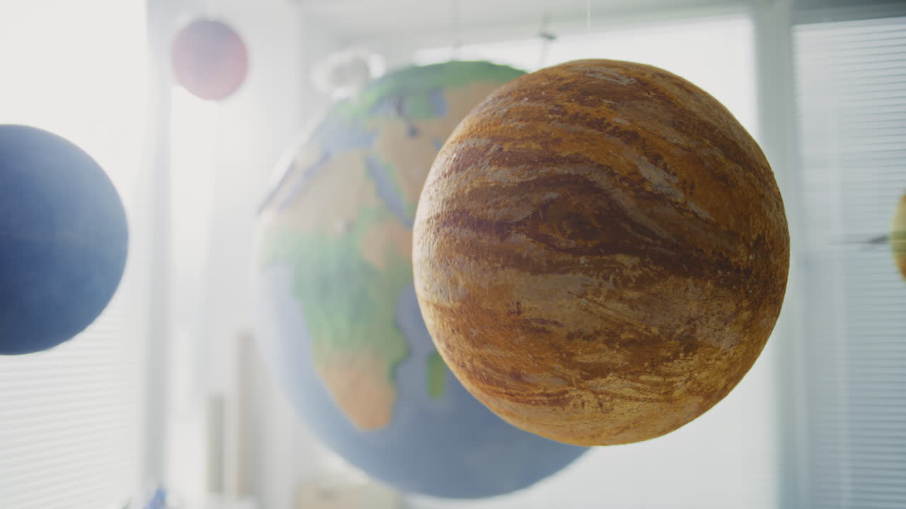 Modern Elementary School Classroom Close Up of Hanging Models of Solar System and Planets