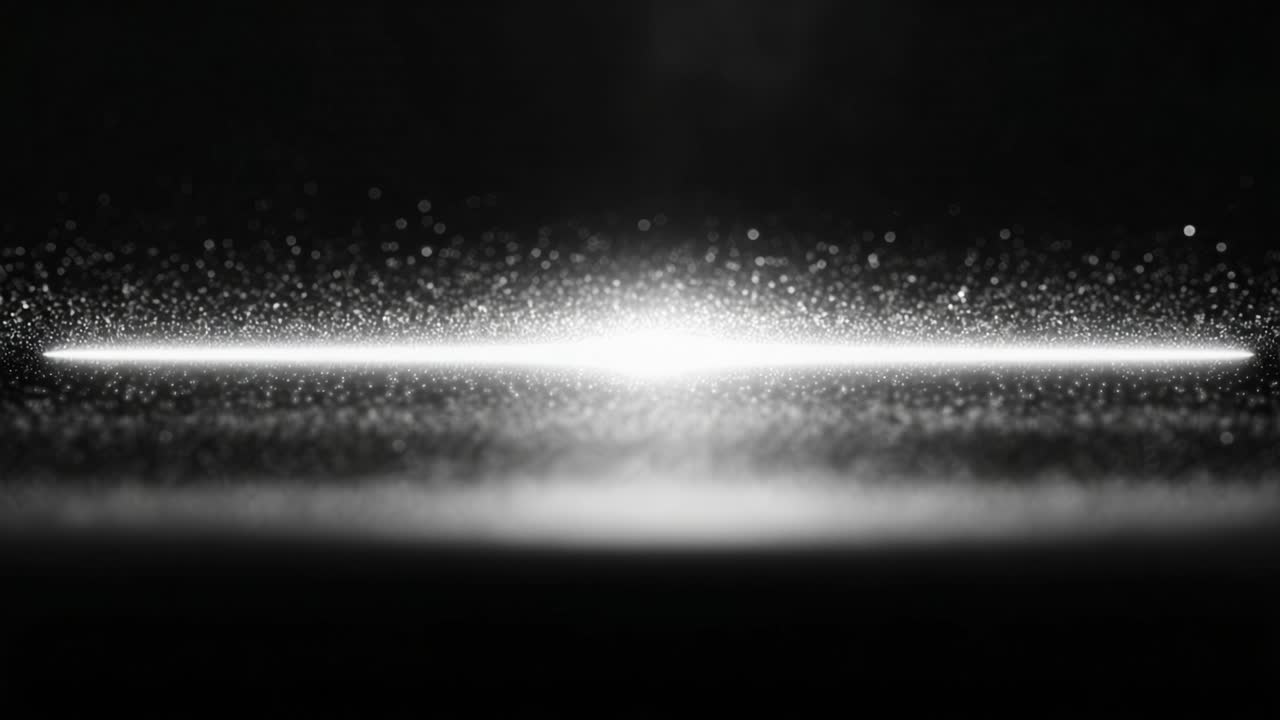 Funklende partikler svæver hypnotiserende i luften. Mod en kulsort baggrund skaber de en fortryllende visuel oplevelse, der fanger beskueren.