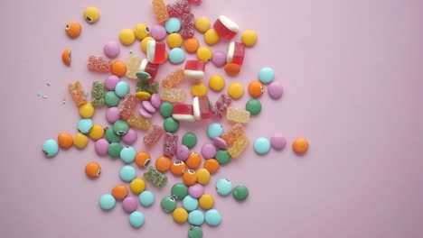 colorful candy pile on pink background