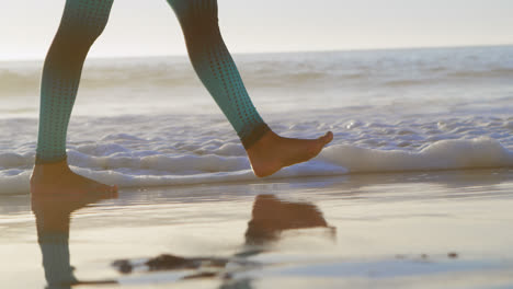 fit woman walking in the beach 4k