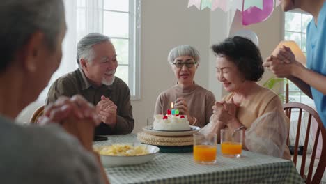 birthday party at senior daycare,group of asian female elder male female laugh smile positive conversation greeting in birthday friend party at nursing home senior daycare center Senior woman birthday