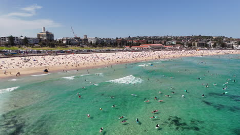 drone shot of bondi beach, showcasing people surfing, sunbathing, and relaxing along the coastline. aerial view, nsw, australia