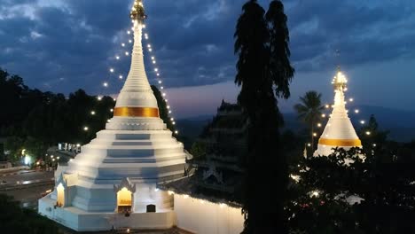 aerial footage night time of phra that doi kong moo, buddhism temple which is the landmark of mae hong son, the northern of thailand