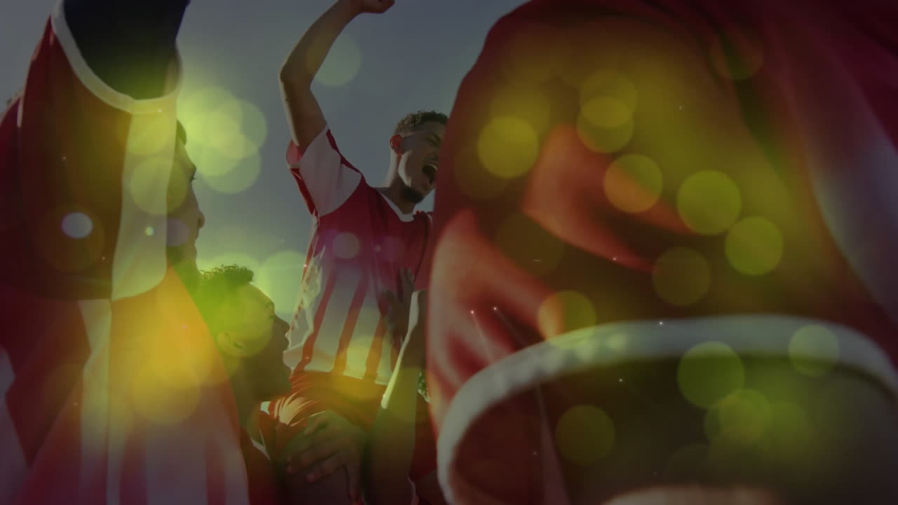 Fans cheering outdoors, with animated yellow-green bokeh flares boosting sports marketing visuals