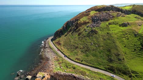descending aerial video of the antrim coastal route on a bright and sunny day. filmed in ballygally in 4k, 60fps and with rec800 color.