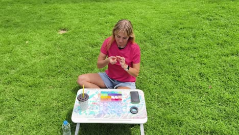 woman making bracelets outdoors