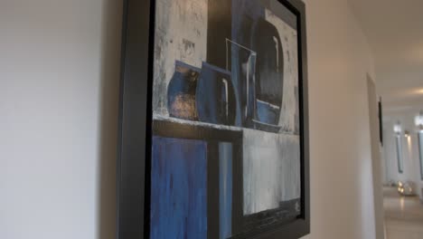 slow revealing shot of artwork hanging in a hallway within a villa