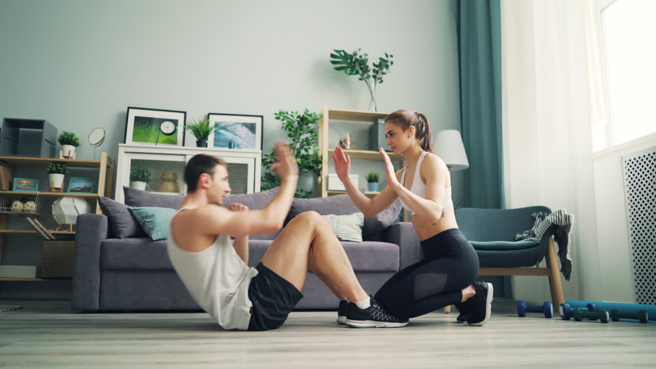 Couple Doing Sit-Ups at Home