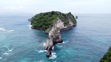 limestone island eroded away off of atuh beach nusa penida indonesia, aerial establish