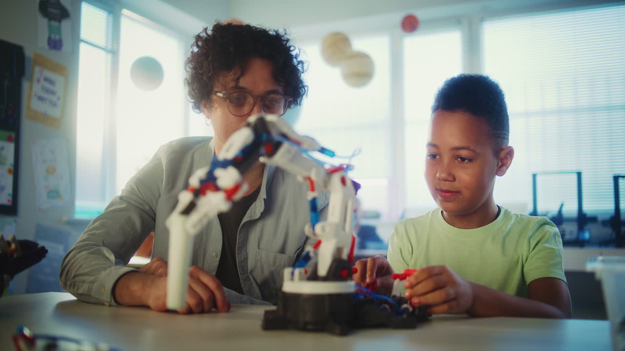 Student and Teacher Working on a Robotic Project