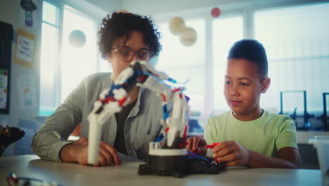 student and teacher working on a robotic project