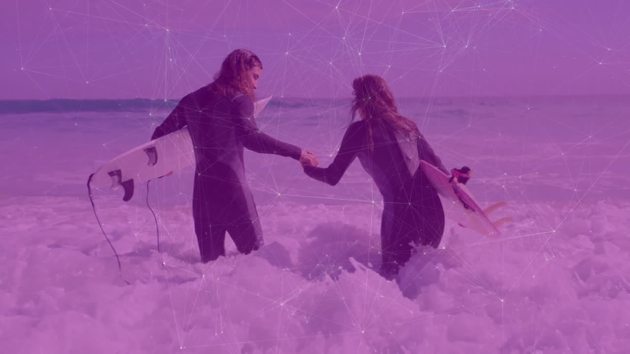 Couple holding hands, wading into surf, carrying surfboards, showcasing health heart icon overlay