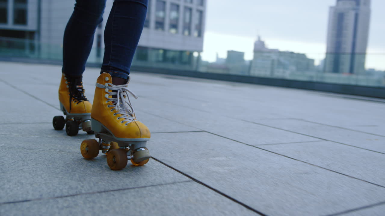 Pemain sepatu roda sporty melakukan elemen skating di luar ruangan. Wanita mengendarai sepatu roda.